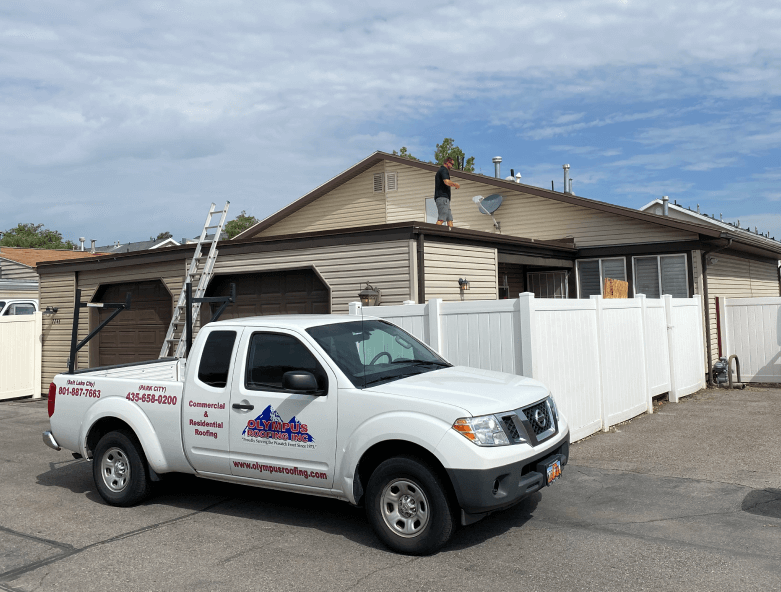 Olympus Wooden House with Olympus Truck during a roof inspection